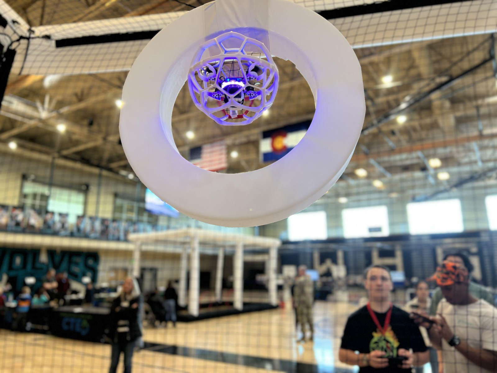A protected drone ball passing through a circular goal ring